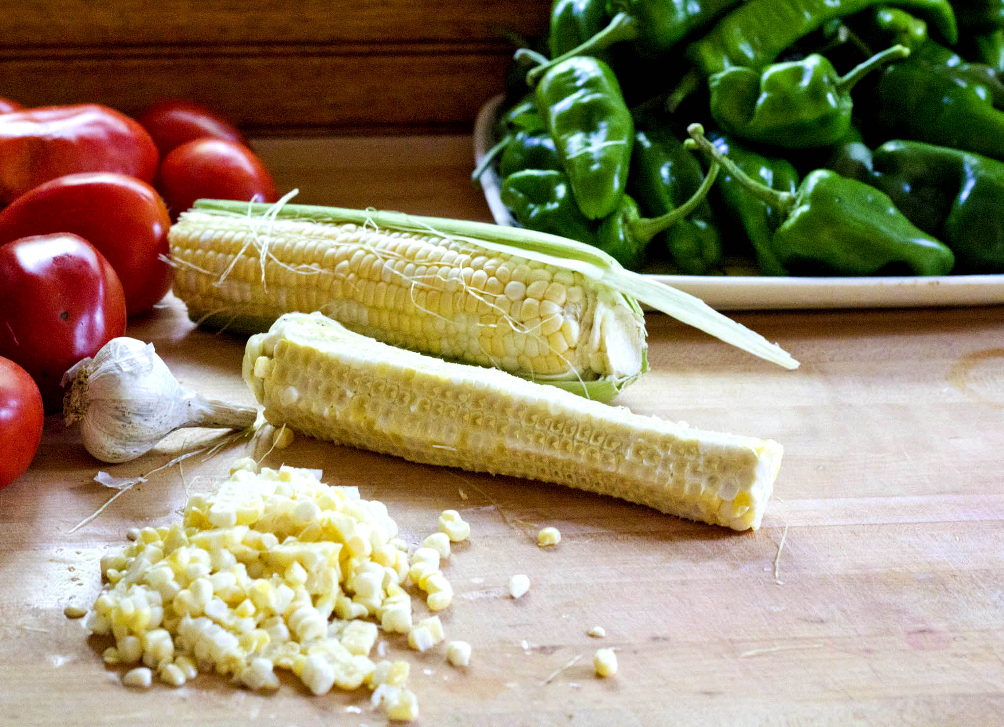 Summer tomato soup with corn cob broth served in a fresh tomato bowl
